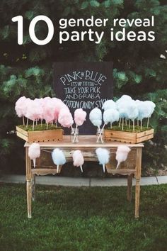 a table with cotton candy on it and a sign in the background that says gender reveal