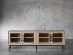 the sideboard is made out of wood and has three glass doors on one side