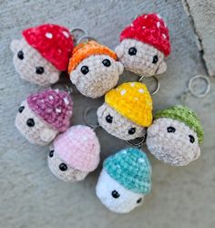 small crocheted keychains with different colored hats on them