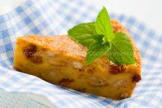 a piece of food that is sitting on a napkin with a green leaf on top