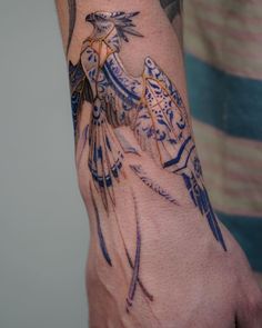 a person's arm with tattoos on it and a bird in the middle of their arm