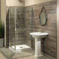 a bathroom with a sink, mirror and shower in it's corner stall area