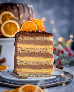 a slice of cake on a plate with orange slices