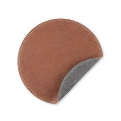 a brown and grey leather mouse pad on a white surface with a gray stripe around the edge