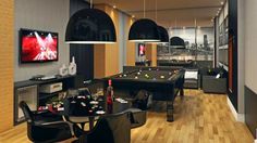 a game room with pool tables, chairs and television in the corner on the wall