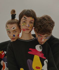 three children with face paint on their faces