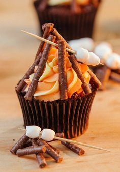 several cupcakes with sticks sticking out of them