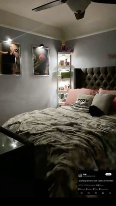 a large bed sitting in a bedroom next to two pictures on the wall