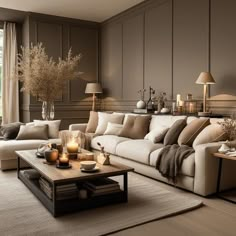 a living room filled with lots of furniture next to a large window and a coffee table