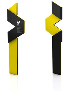 an abstract black and yellow object is shown in three different angles, including the letter e