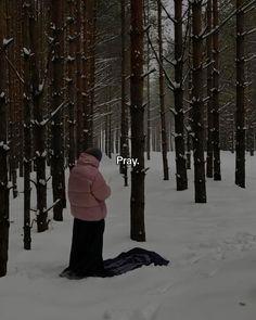 a person standing in the middle of a forest with snow on it and trees all around