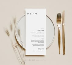 a white menu card sitting on top of a plate next to a fork and knife