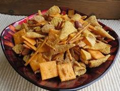 a bowl filled with cheetos sitting on top of a table