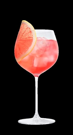 a pink drink in a wine glass garnished with an orange slice