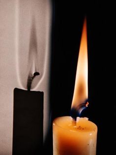 a lit candle sitting next to a lighter