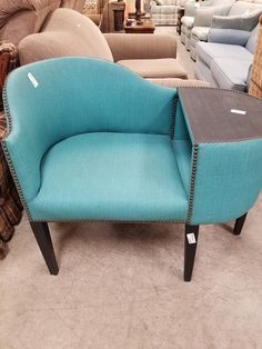 a blue chair sitting on top of a carpet covered floor