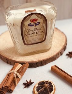 a bottle of vanilla sitting on top of a table next to cinnamon sticks and star anise