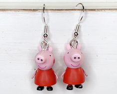 These adorable pig earrings are the best way to show your love for fashion  Each peppa pig dangles from a hypoallergenic hook  Very lightweight  Each pig is approximately 1 inch tall by 1/4 inch wide Pig Earrings, Pig Jewelry, Peppa Pig, Jewelry Earrings Dangle, Etsy Earrings, Dangle Drop Earrings, Lily, Dangle Earrings, Jewelry Earrings