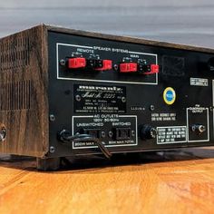 an old radio sitting on top of a wooden table