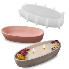 two trays with candles and flowers on them, one is pink and the other is white