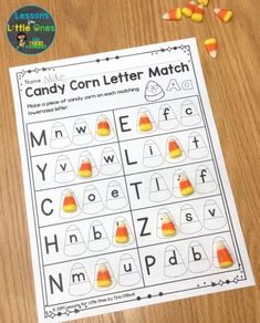 candy corn letter match is shown on a table with candy cones and candy canes