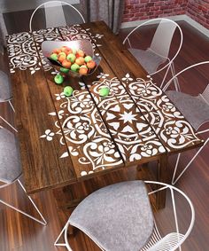 a wooden table with chairs around it and a bowl of fruit on top of it