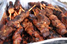 several skewered meats are in a plastic container