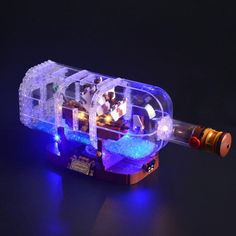 a lego light up ship with blue lights on it's sides and the bottom part is