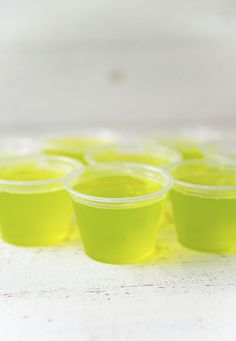 small plastic cups are lined up on the table