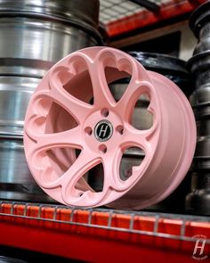 some pink wheels are stacked on top of each other