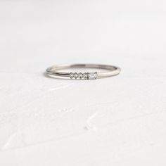 Your choice of one number in Morse Code from the available dropdown options. Depending on your chosen design, this ring features round (1mm) and/or baguette (1.25x2mm) diamonds set on a delicate 1.2mm band—available in platinum or 14k solid yellow, white or rose gold. All accent diamonds are SI clarity and G+ color. We handcraft each piece with responsibly sourced 14k gold and ethically sourced stones. Click here for Morse Code Rings: Initials Morse Code Ring, Handcrafted Engagement Ring, 1 Number, Plastic Ring, Baguette Diamonds, Morse Code, Secret Messages, Ring Sizer, High Standards