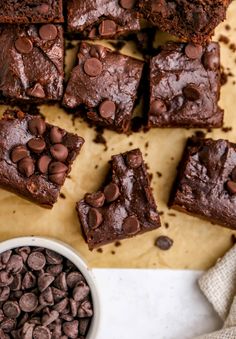 brownies with chocolate chips are on a cutting board