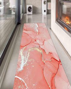 the floor is covered in pink and white marble, with an electric fire place next to it