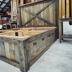 a bed frame made out of wooden planks in the middle of a snow covered floor