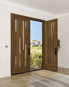 an empty room with two doors open and a potted plant on the floor next to it