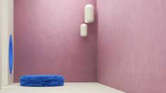 a blue towel sitting on top of a white floor next to a wall mounted light