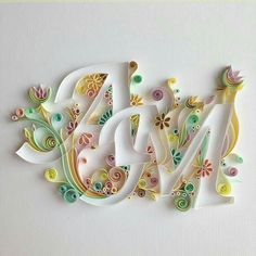 the word art is made out of paper and decorated with colorful flowers, leaves and swirls