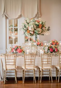 an elegant wedding reception with tall centerpieces