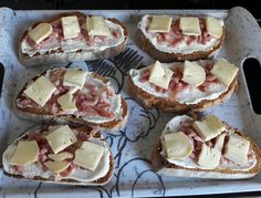 several pieces of bread topped with meat and cheese