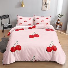 a pink bed with cherries on it