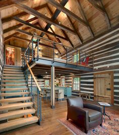 the inside of a log cabin with stairs