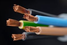 three wires connected to each other with copper and blue wires in the middle one is green