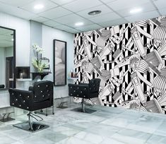 the salon is decorated with black and white wallpaper, chairs, and art work