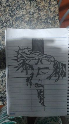 a notepad with a drawing of jesus on it