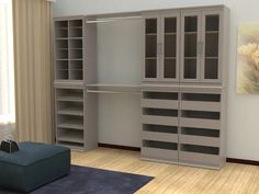 a room with a couch, bookshelf and cabinets in it