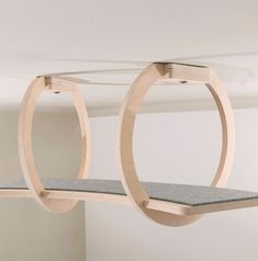 a pair of circular wooden shelves hanging from the ceiling