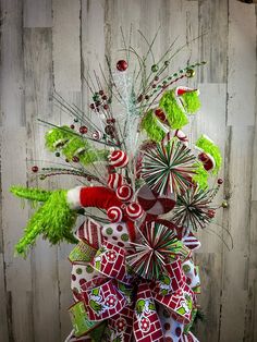 a red and white christmas tree with candy canes