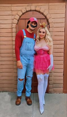 a man and woman in costumes standing next to each other