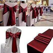 red and white chair covers with bows on them are set up for a wedding reception