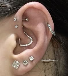 a woman with three different piercings on her ear